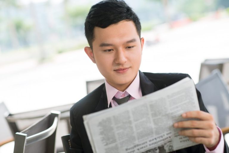 A person reading a public relations press release (illustration)