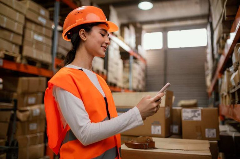 A warehouse worker is checking items in racks.